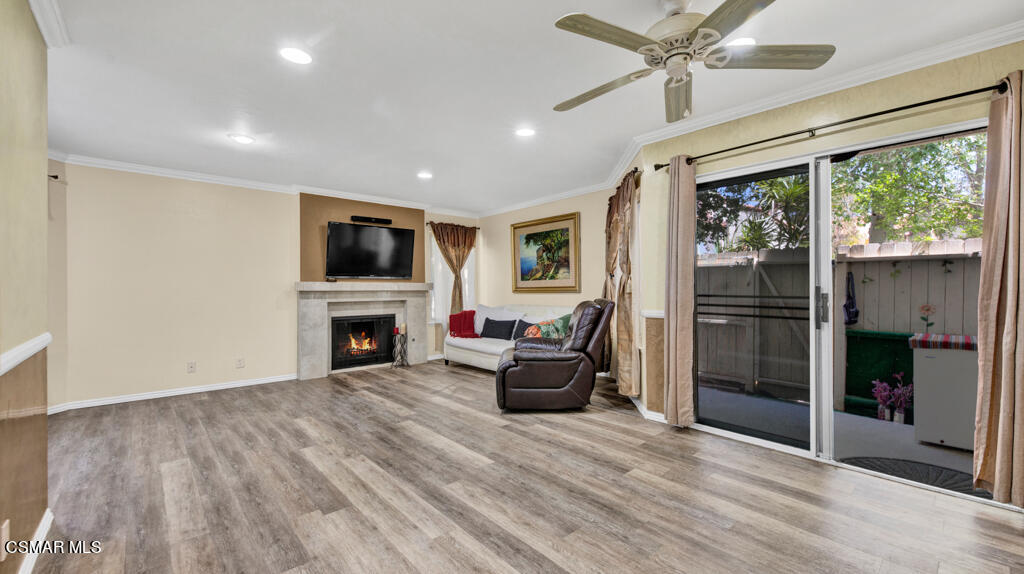 1712 Sinaloa Road, Unit 106 Simi Valley, CA 93065 - Photo 6 of 30 a living room with furniture a fireplace and a flat screen tv