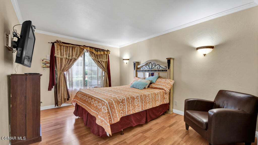 1712 Sinaloa Road, Unit 106 Simi Valley, CA 93065 - Photo 10 of 30 a bedroom with a bed couch and a window