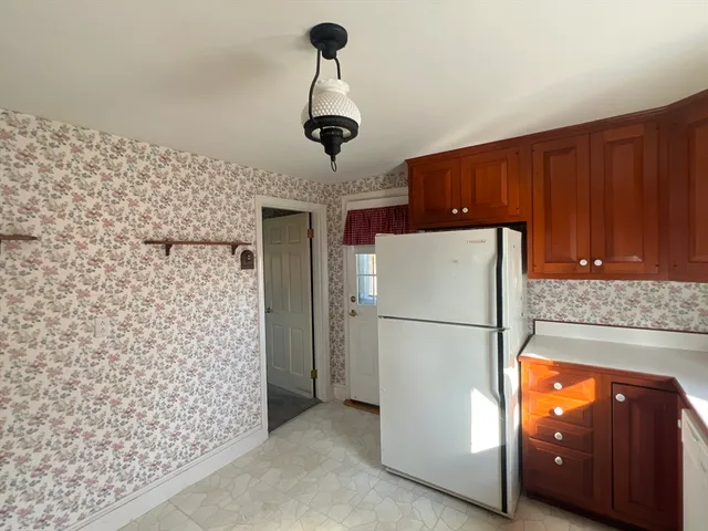 a kitchen with stainless steel appliances a refrigerator and a cabinets