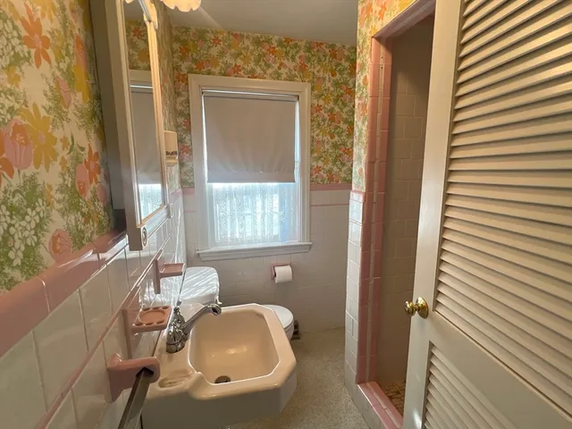 a bathroom with a tub and window