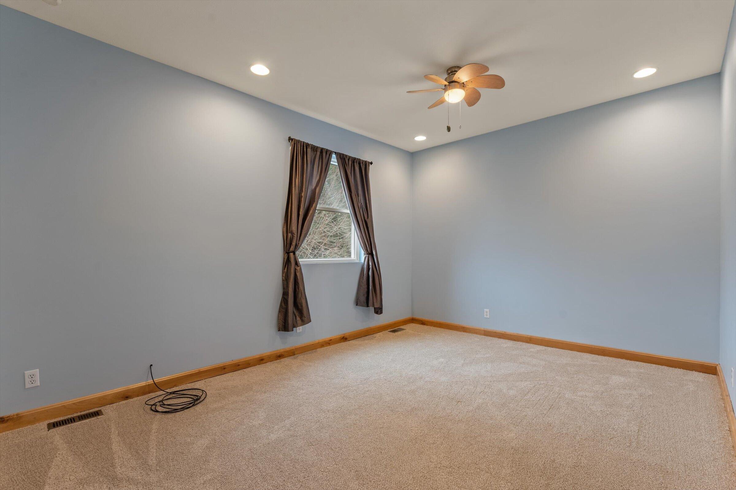 7692 North Emery Road Rolling Prairie, IN 46371 - Photo 35 of 69 an empty room with a window and a ceiling fan view