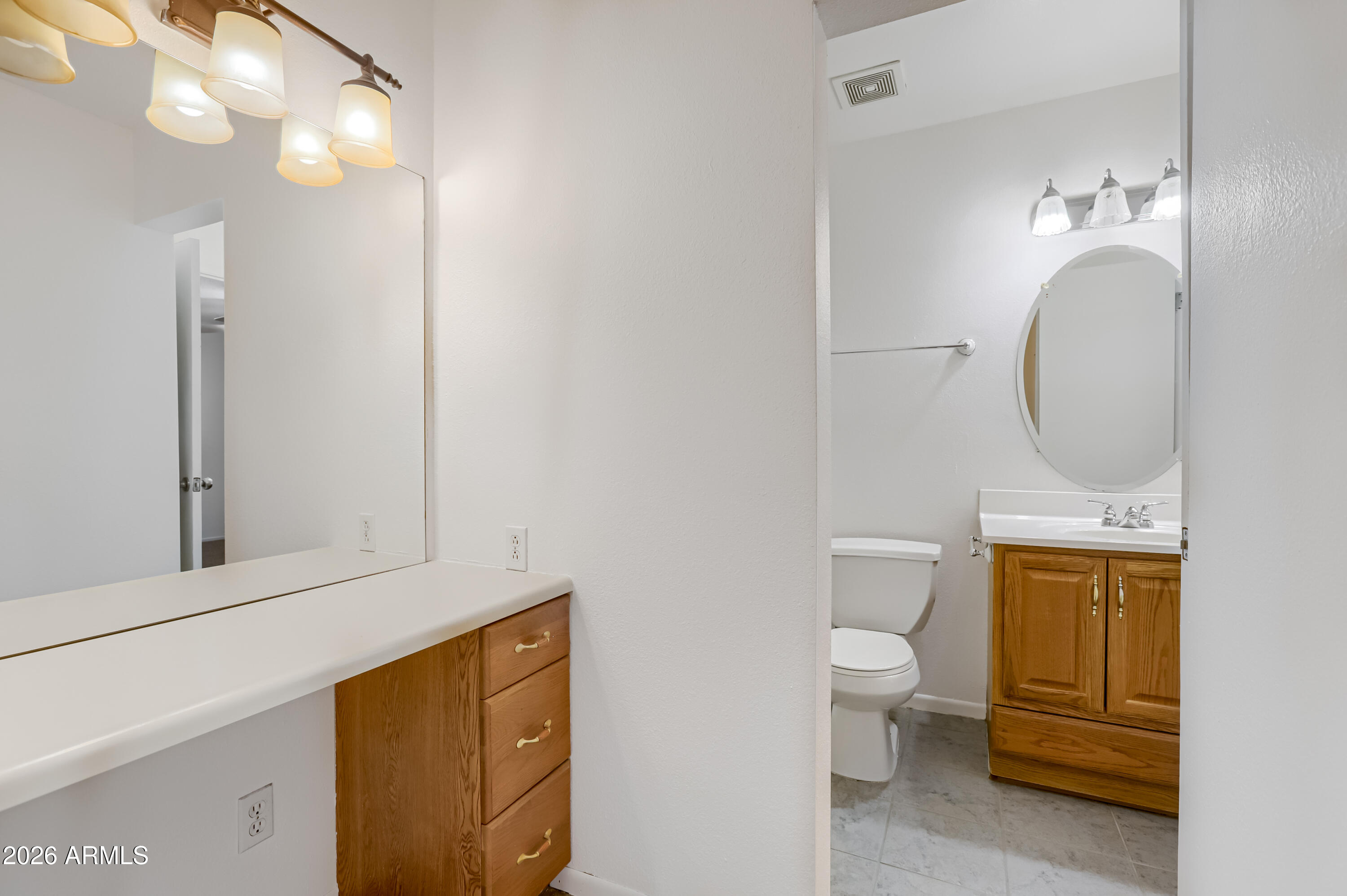 3823 West Greenway Road Phoenix, AZ 85053 - Photo 22 of 28 a bathroom with a toilet sink vanity granite and mirror