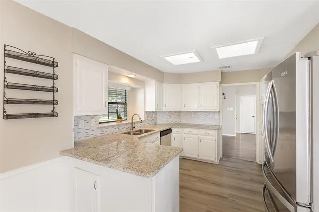 a kitchen with a sink stove and cabinets