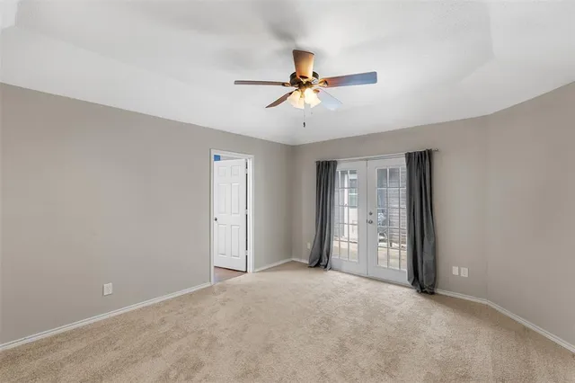 a view of a room with closet and ceiling fan