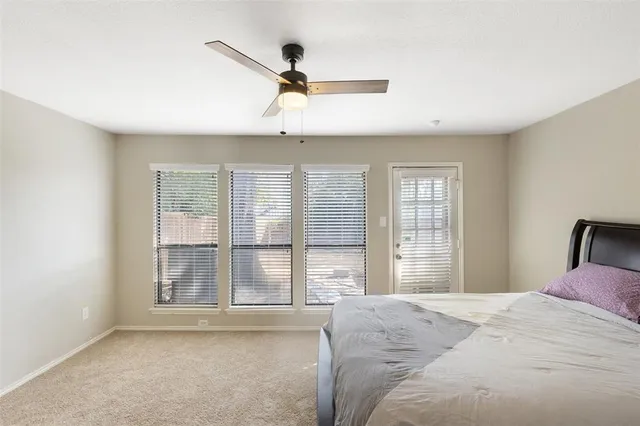 a bedroom with a large bed and a large window