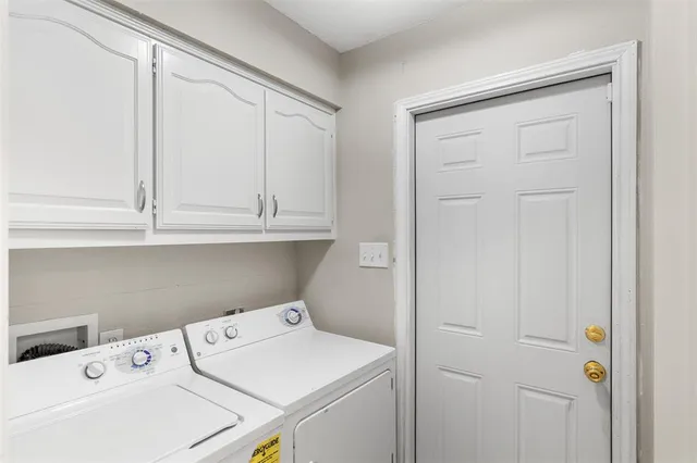 a view of storage and utility room with washer and dryer
