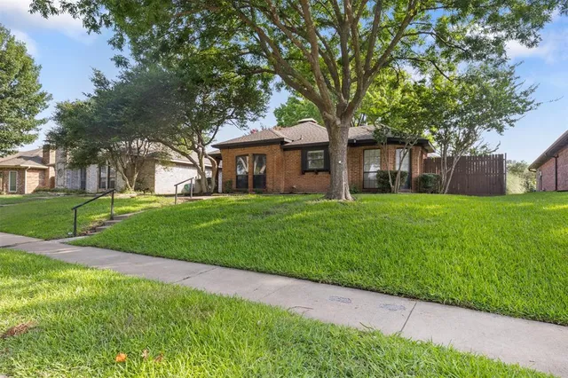 a house view with a sitting space and garden