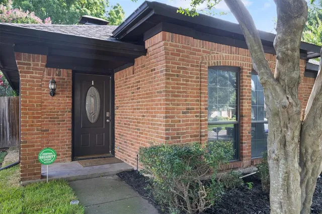 a front view of a house with potted plants