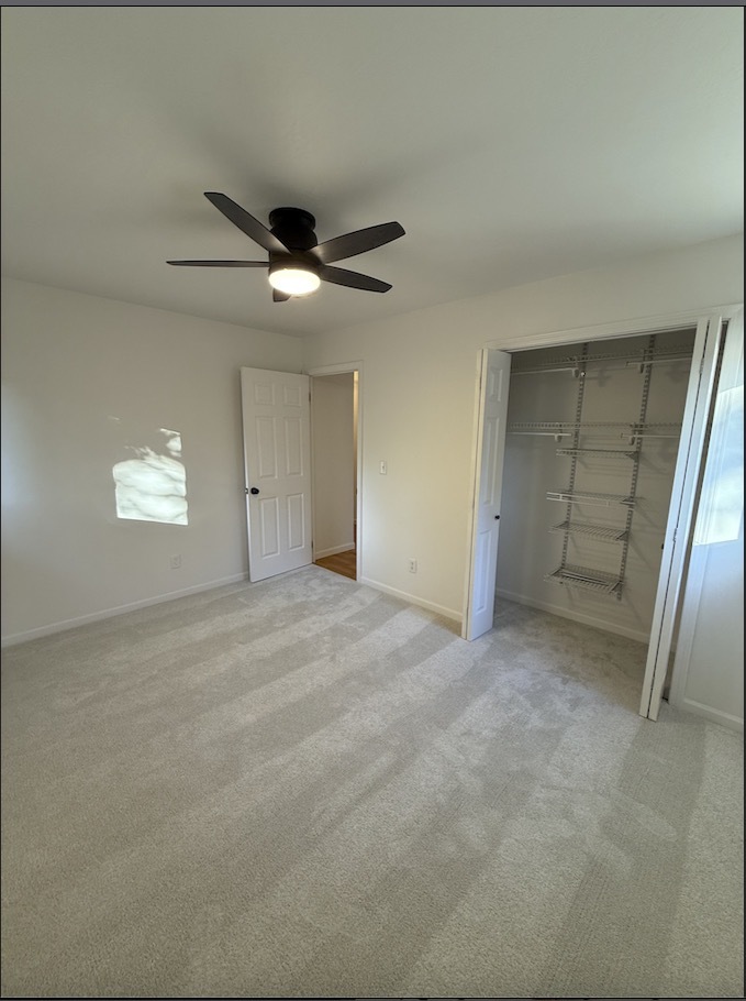1309 Maplepark Drive Champaign, IL 61821 - Photo 13 of 24 a view of an empty room and a ceiling fan