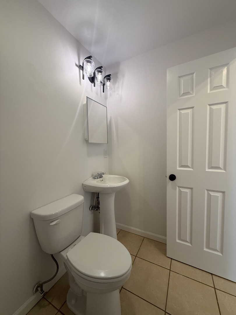 1309 Maplepark Drive Champaign, IL 61821 - Photo 21 of 24 a bathroom with a toilet sink and shower