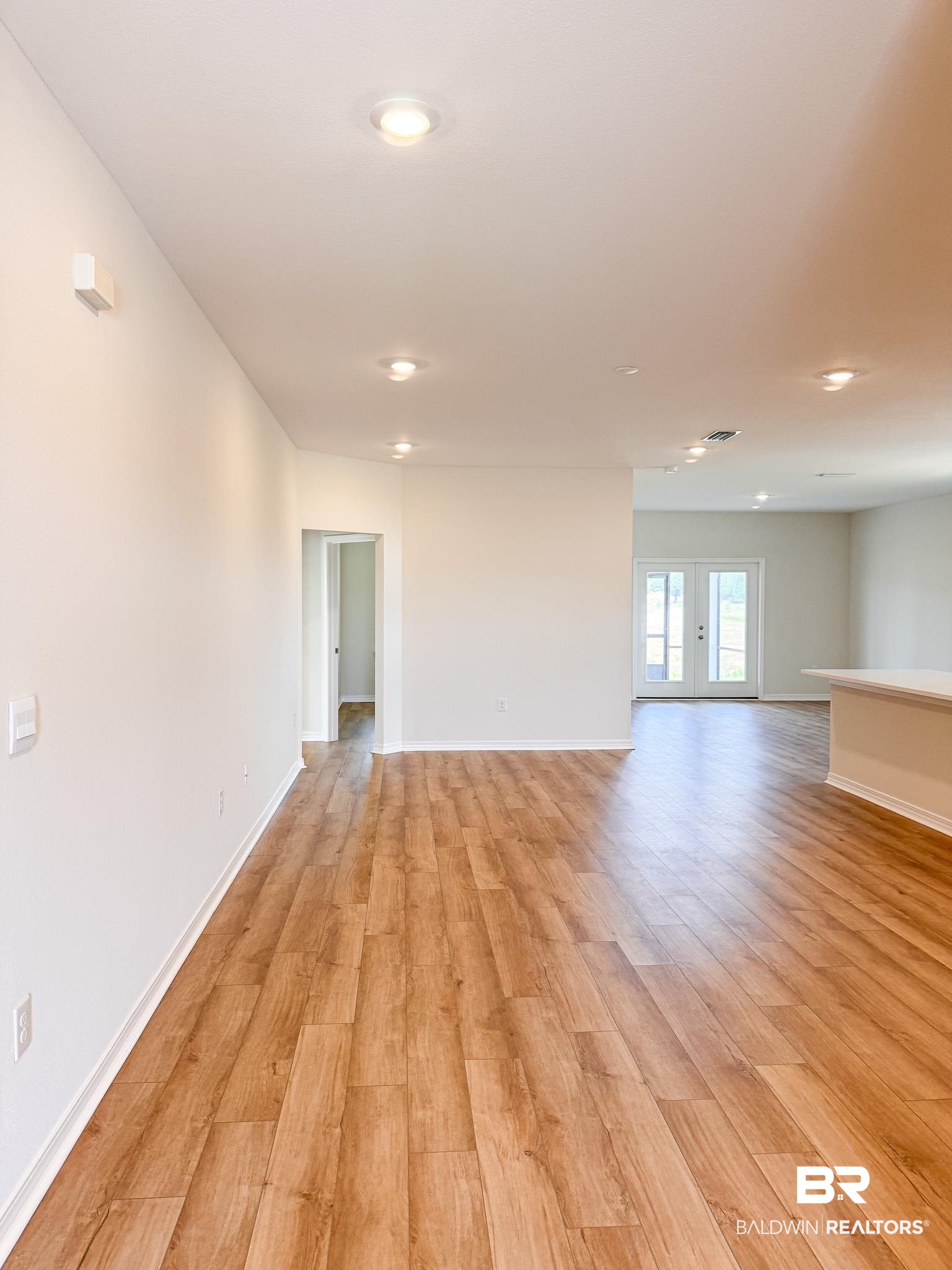 18151 Kent Circle Foley, AL 36535 - Photo 5 of 25 Expansive interior featuring wood-finish flooring, recessed lighting, white walls, and bright white trim