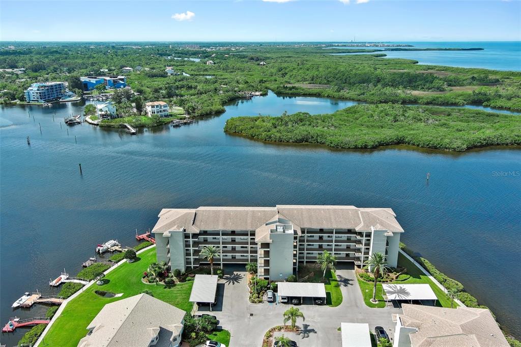 an aerial view of a house with a garden and lake view