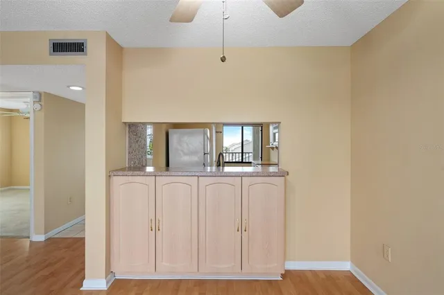 a kitchen with granite countertop a sink stove and cabinets