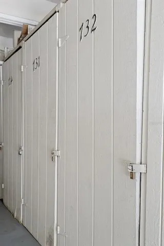 a view of swimming pool with lawn chairs and a big yard