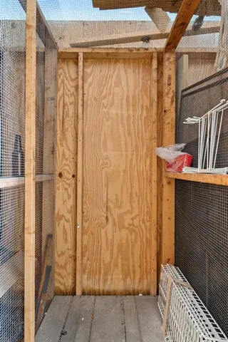 a front view of a house with palm trees