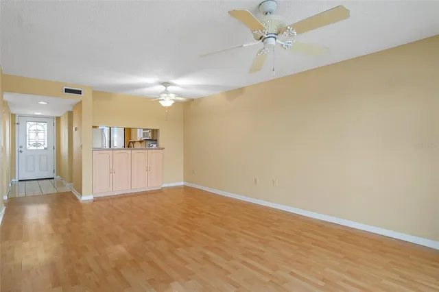 a view of an empty room and wooden floor