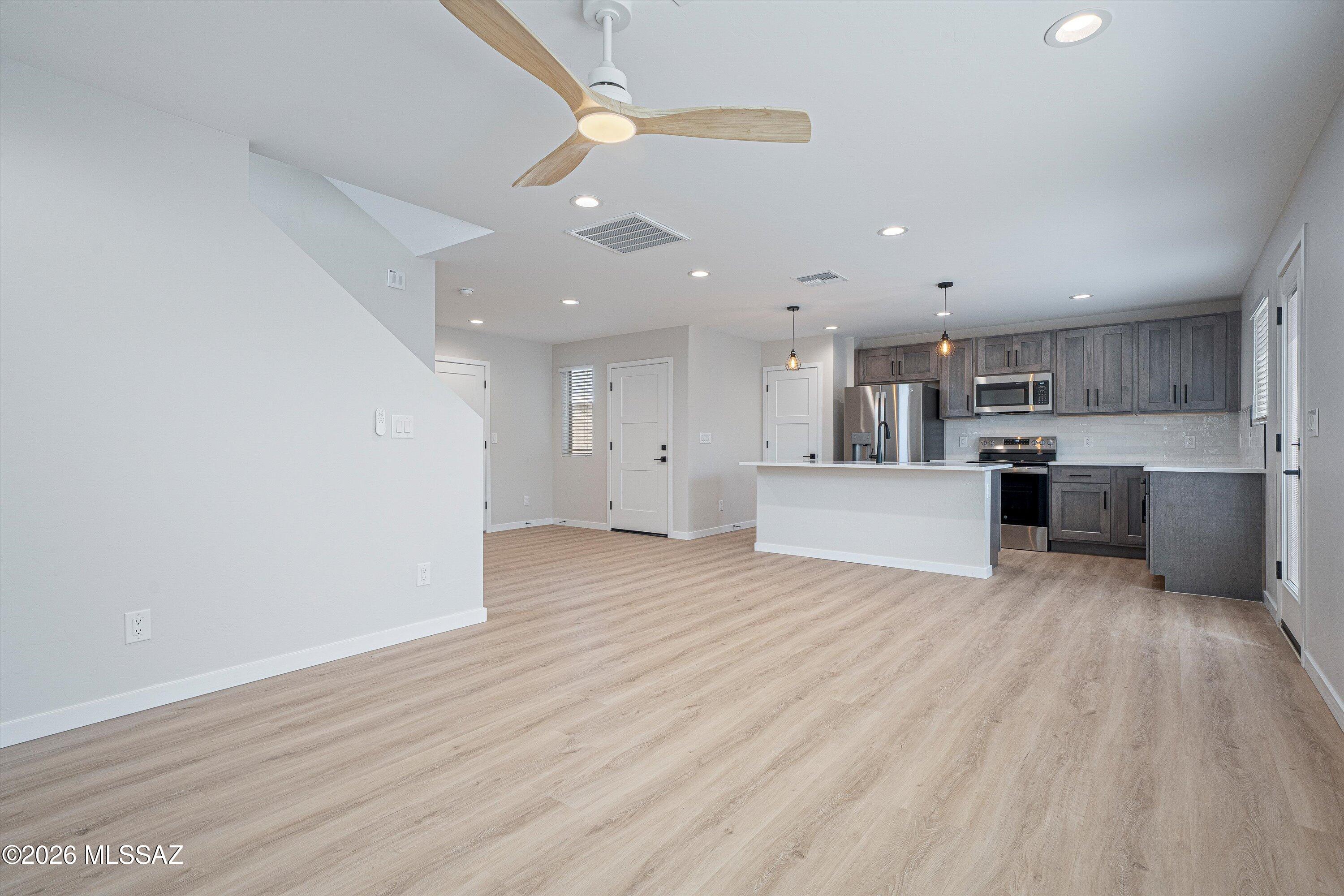 739 North Queen Avenue, Unit 2 Tucson, AZ 85705 - Photo 20 of 28 a view of kitchen with wooden floor and electronic appliances