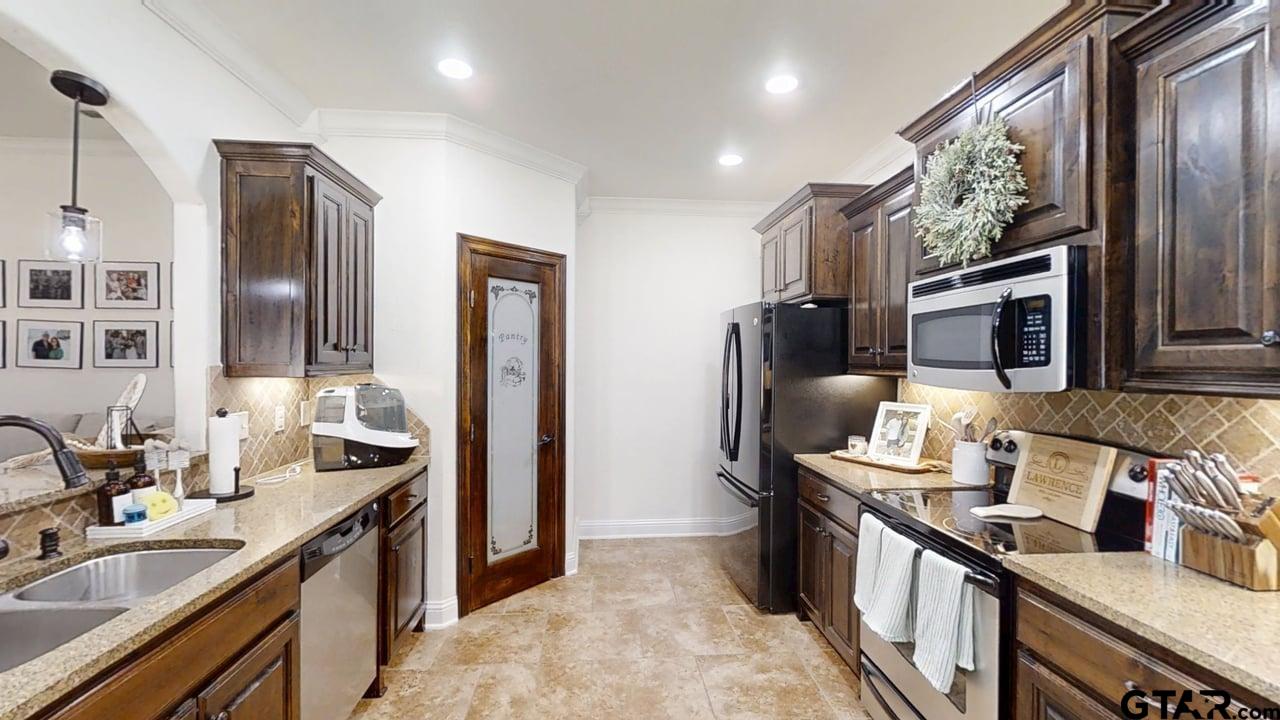 809 Crepe Myrtle Lane Longview, TX 75604 - Photo 11 of 39 a kitchen with stainless steel appliances granite countertop a sink stove and refrigerator