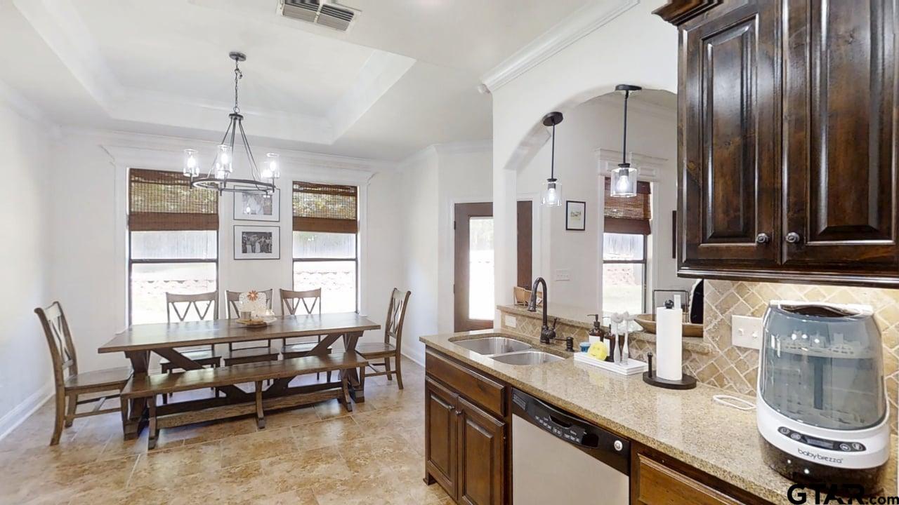 809 Crepe Myrtle Lane Longview, TX 75604 - Photo 13 of 39 a kitchen with stainless steel appliances granite countertop a sink and a refrigerator