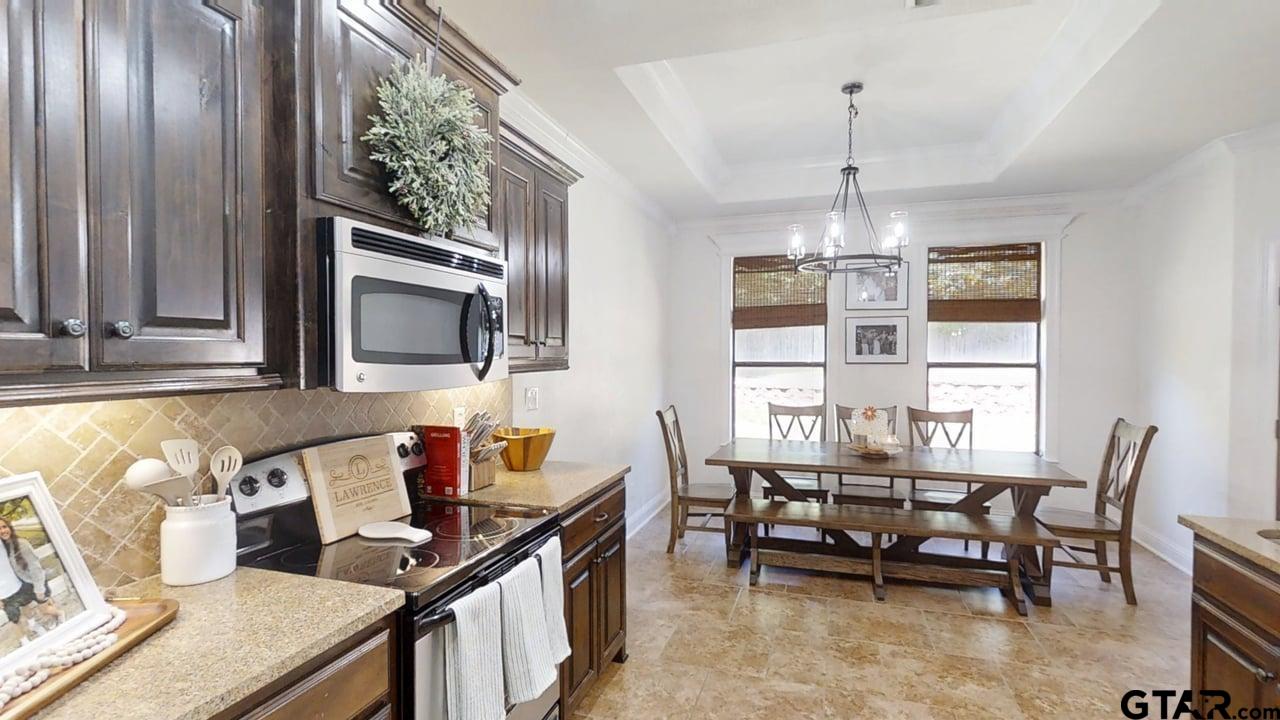 809 Crepe Myrtle Lane Longview, TX 75604 - Photo 15 of 39 a view of a dining room with furniture a chandelier and wooden floor