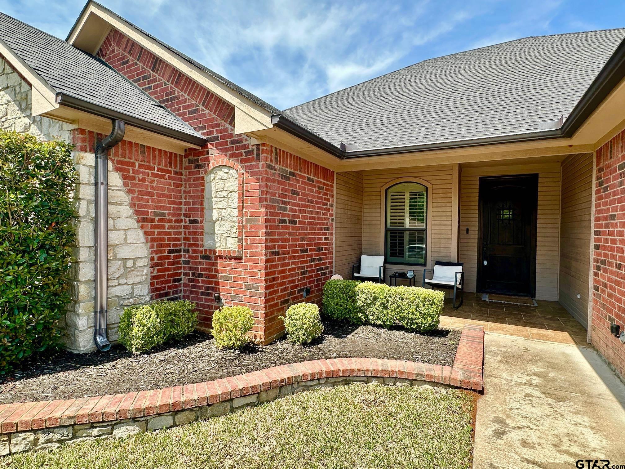 809 Crepe Myrtle Lane Longview, TX 75604 - Photo 2 of 39 a front view of a house with garden