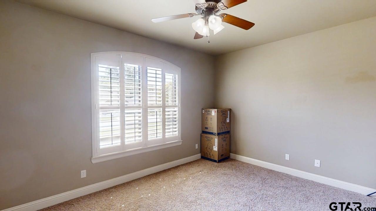 809 Crepe Myrtle Lane Longview, TX 75604 - Photo 28 of 39 an empty room with chandelier fan and windows