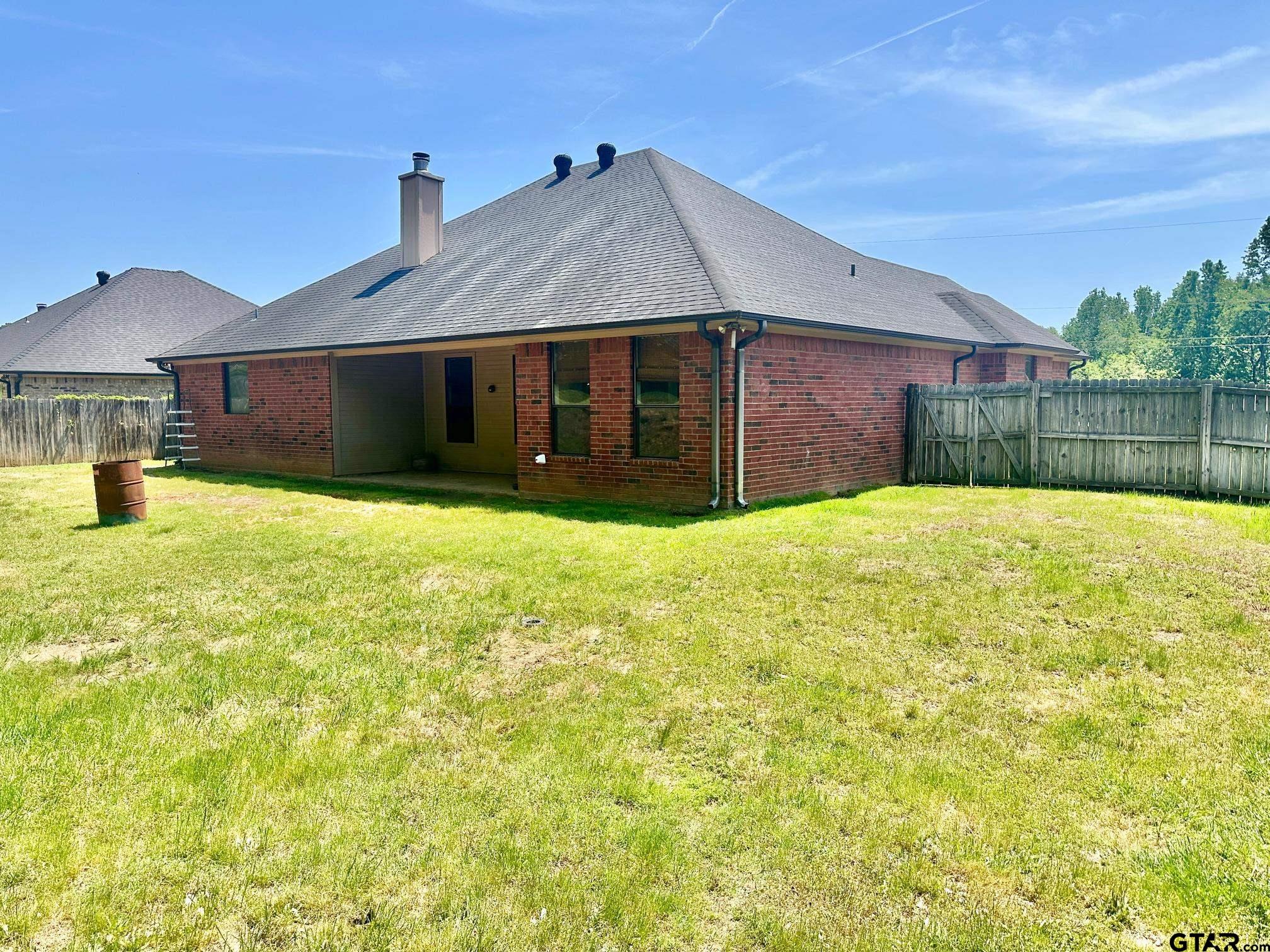 809 Crepe Myrtle Lane Longview, TX 75604 - Photo 32 of 39 a view of a house with a yard and garage