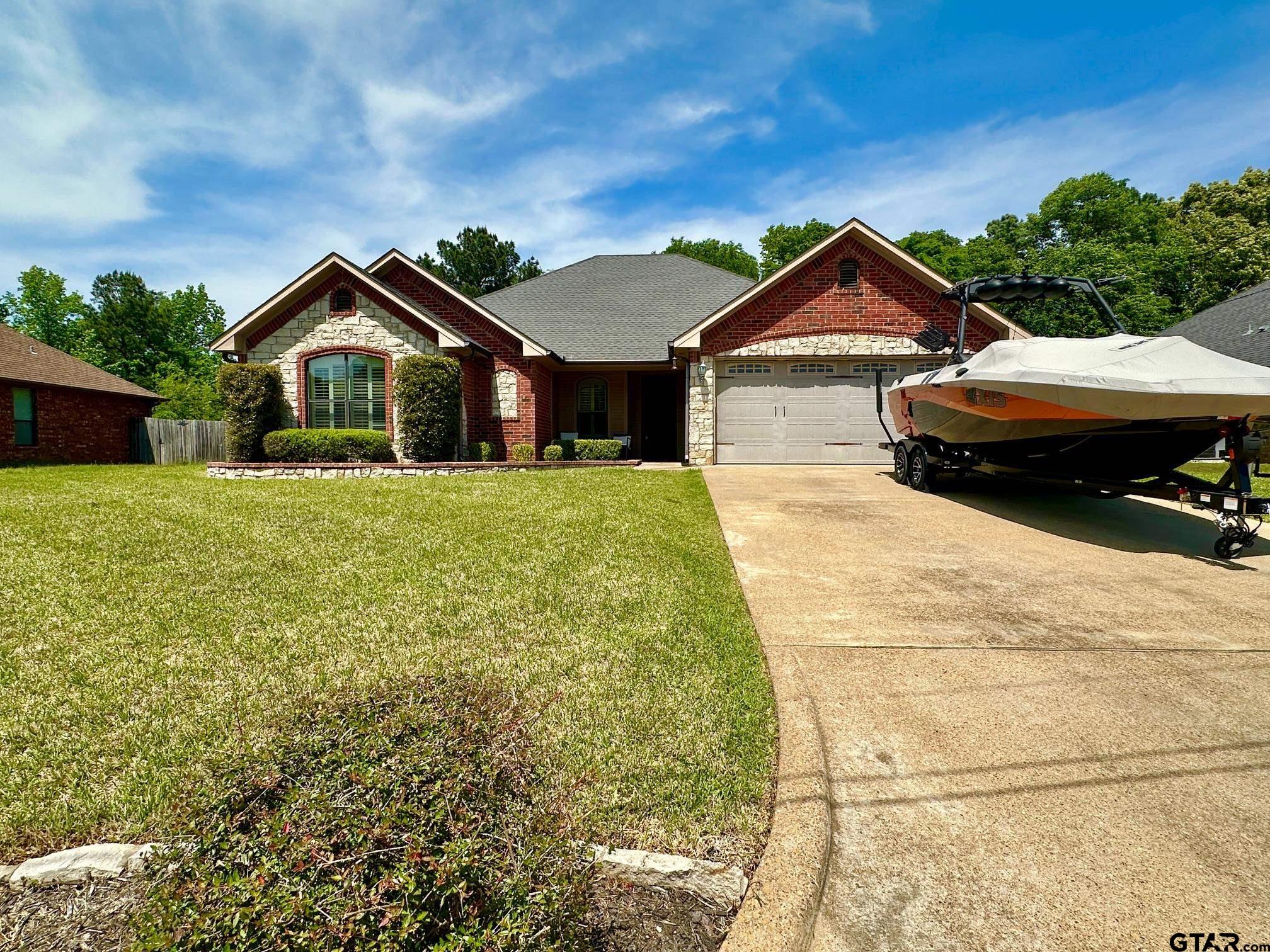 809 Crepe Myrtle Lane Longview, TX 75604 - Photo 37 of 39 a front view of a house with a yard and garage
