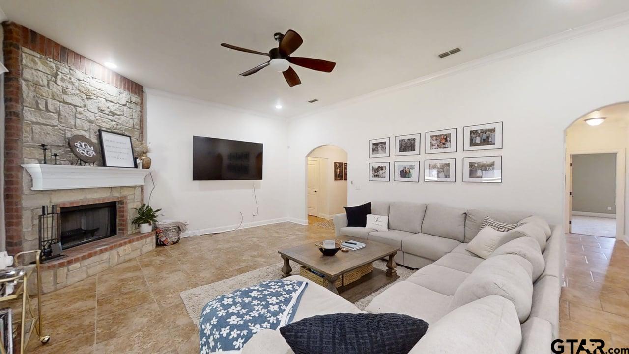 809 Crepe Myrtle Lane Longview, TX 75604 - Photo 6 of 39 a living room with furniture a fireplace and a flat screen tv
