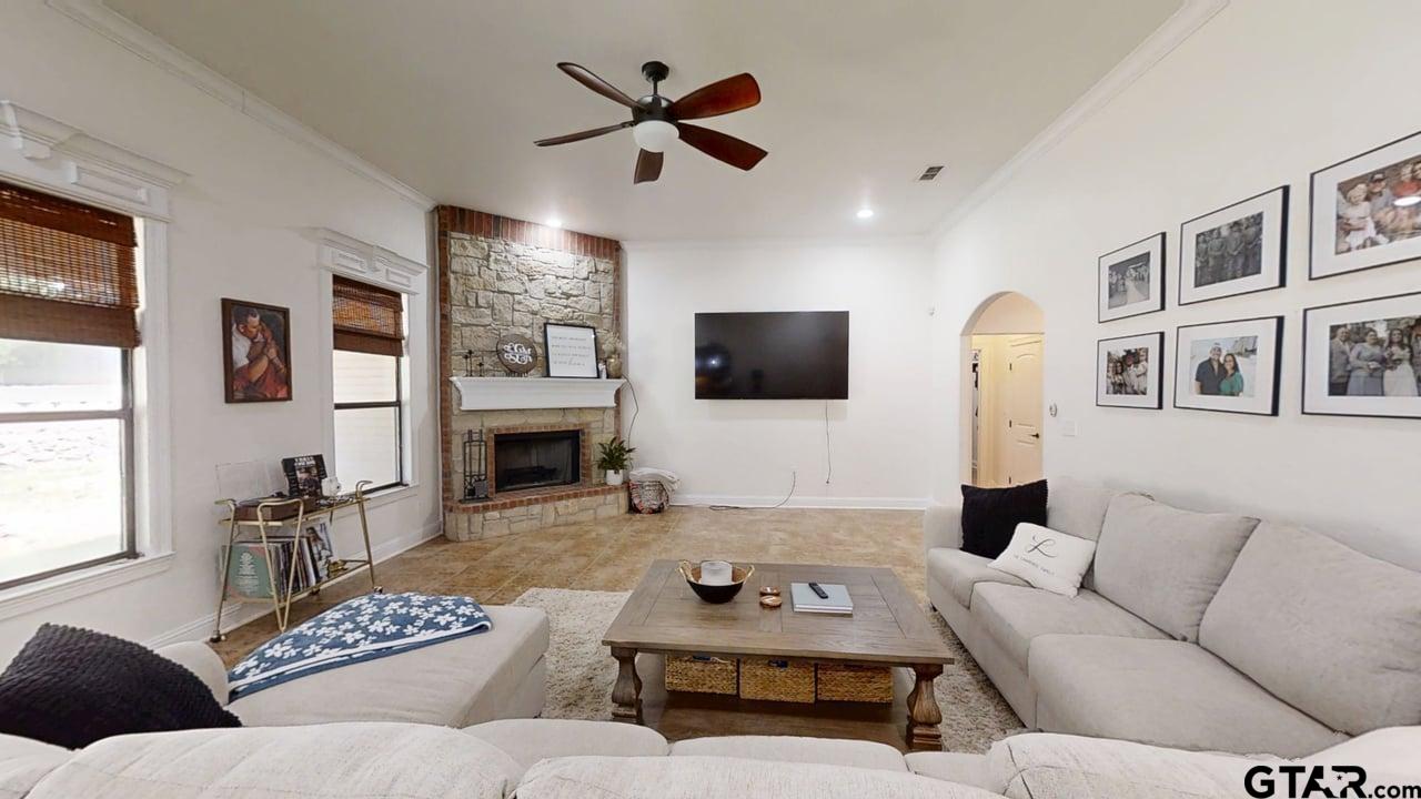 809 Crepe Myrtle Lane Longview, TX 75604 - Photo 7 of 39 a living room with furniture a fireplace and a flat screen tv