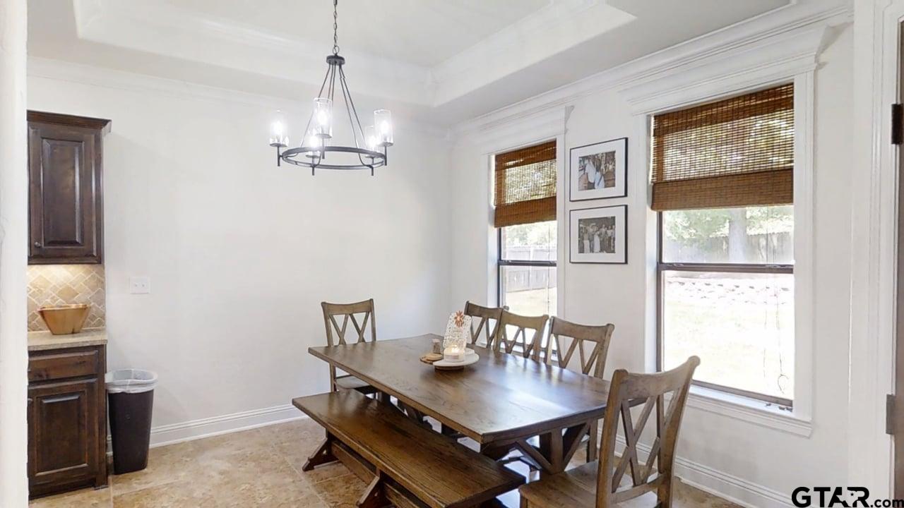 809 Crepe Myrtle Lane Longview, TX 75604 - Photo 9 of 39 a view of a dining room with furniture window and wooden floor
