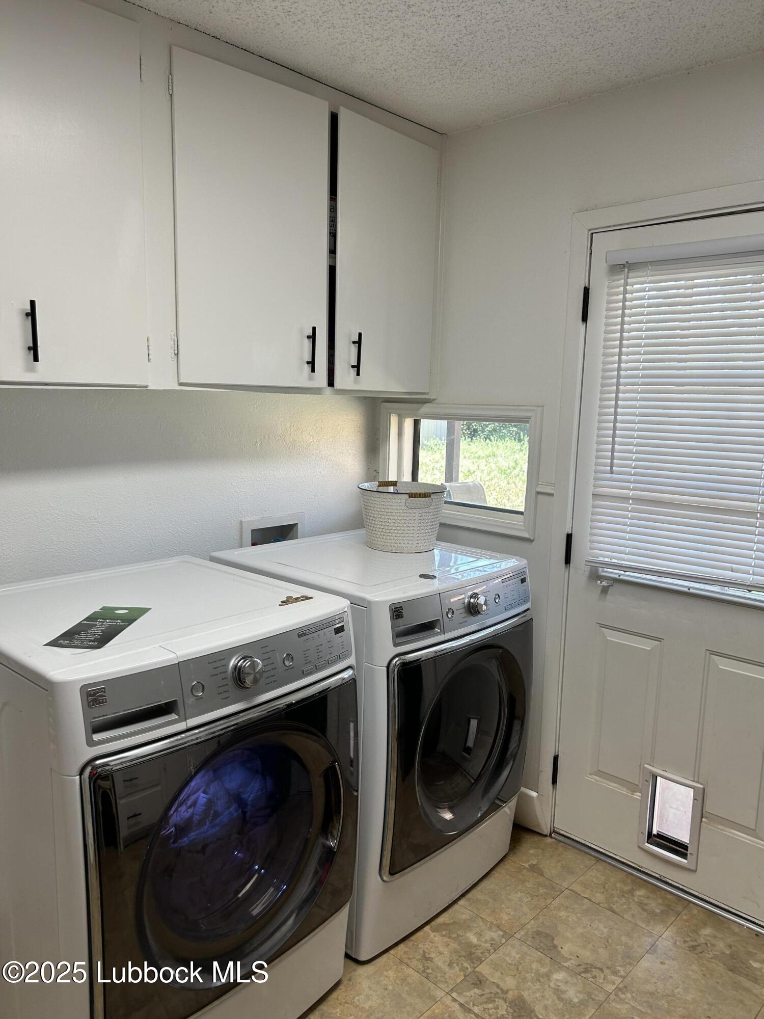 4809 8th Street Lubbock, TX 79416 - Photo 14 of 15 a utility room with dryer and washer