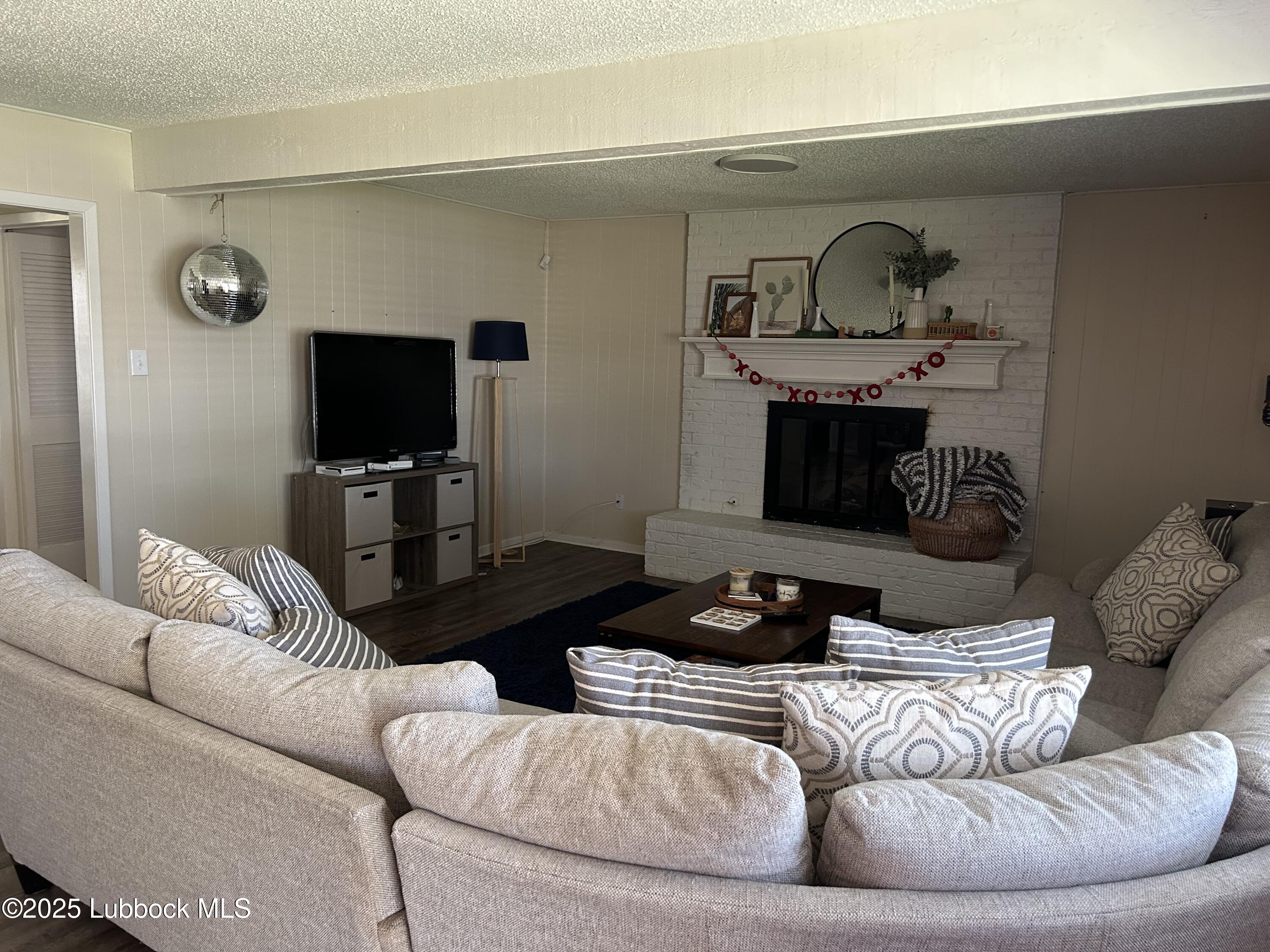 4809 8th Street Lubbock, TX 79416 - Photo 3 of 15 a living room with furniture and a flat screen tv