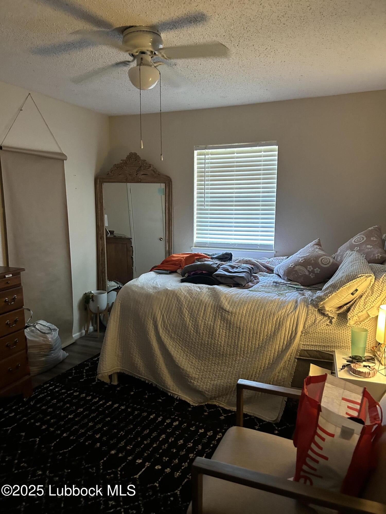 4809 8th Street Lubbock, TX 79416 - Photo 6 of 15 a bedroom with a bed and a window