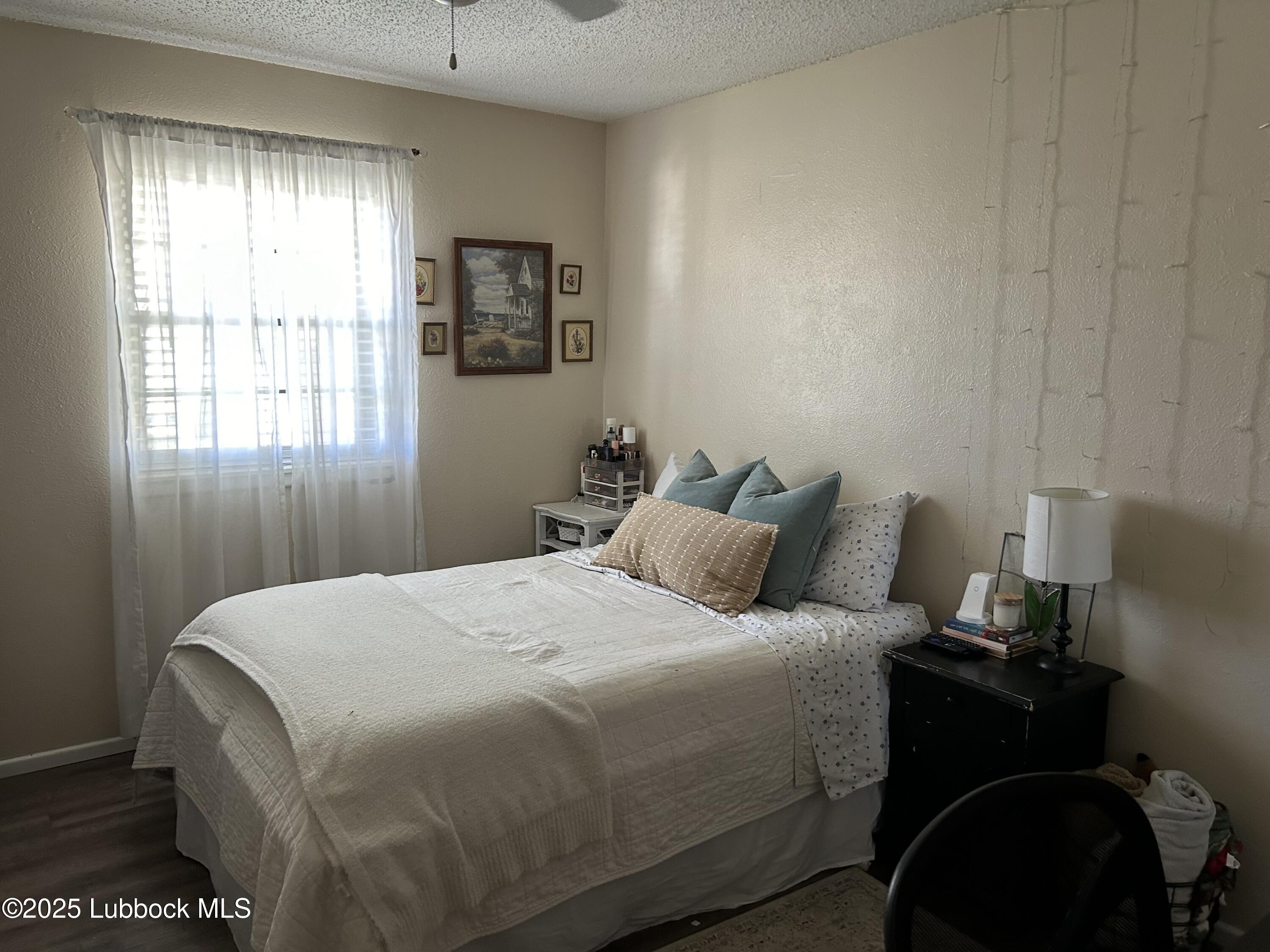 4809 8th Street Lubbock, TX 79416 - Photo 7 of 15 a bedroom with a bed and window