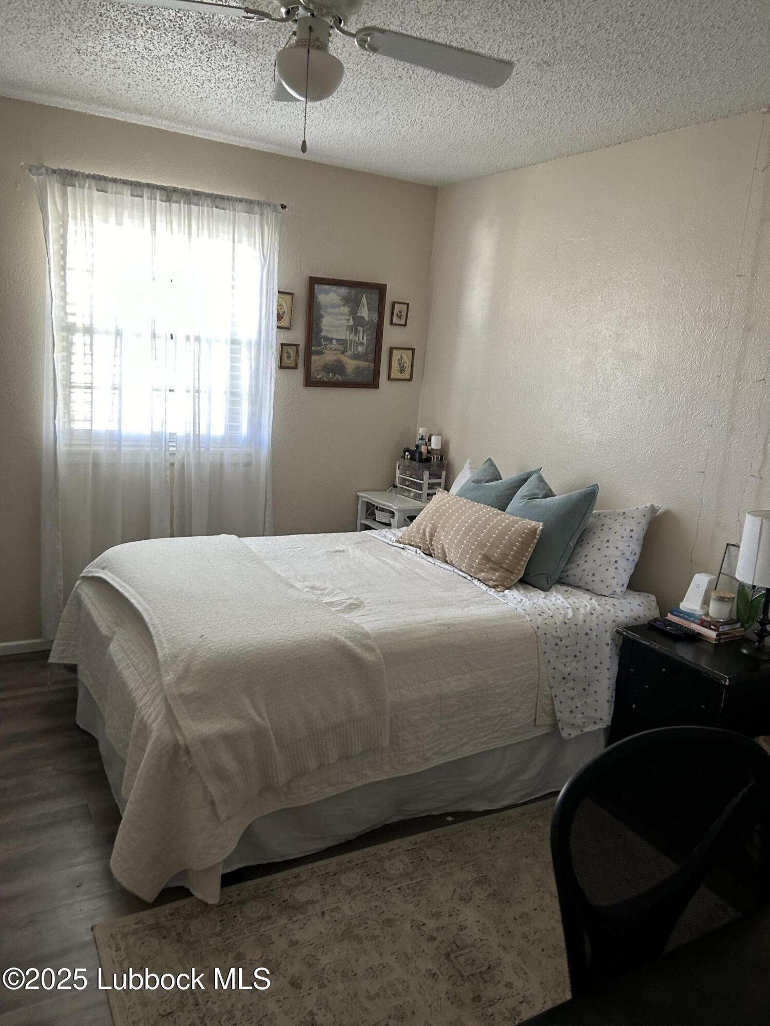 4809 8th Street Lubbock, TX 79416 - Photo 8 of 15 a bedroom with a bed and window