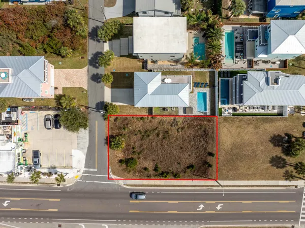 an aerial view of a house with a yard and balcony
