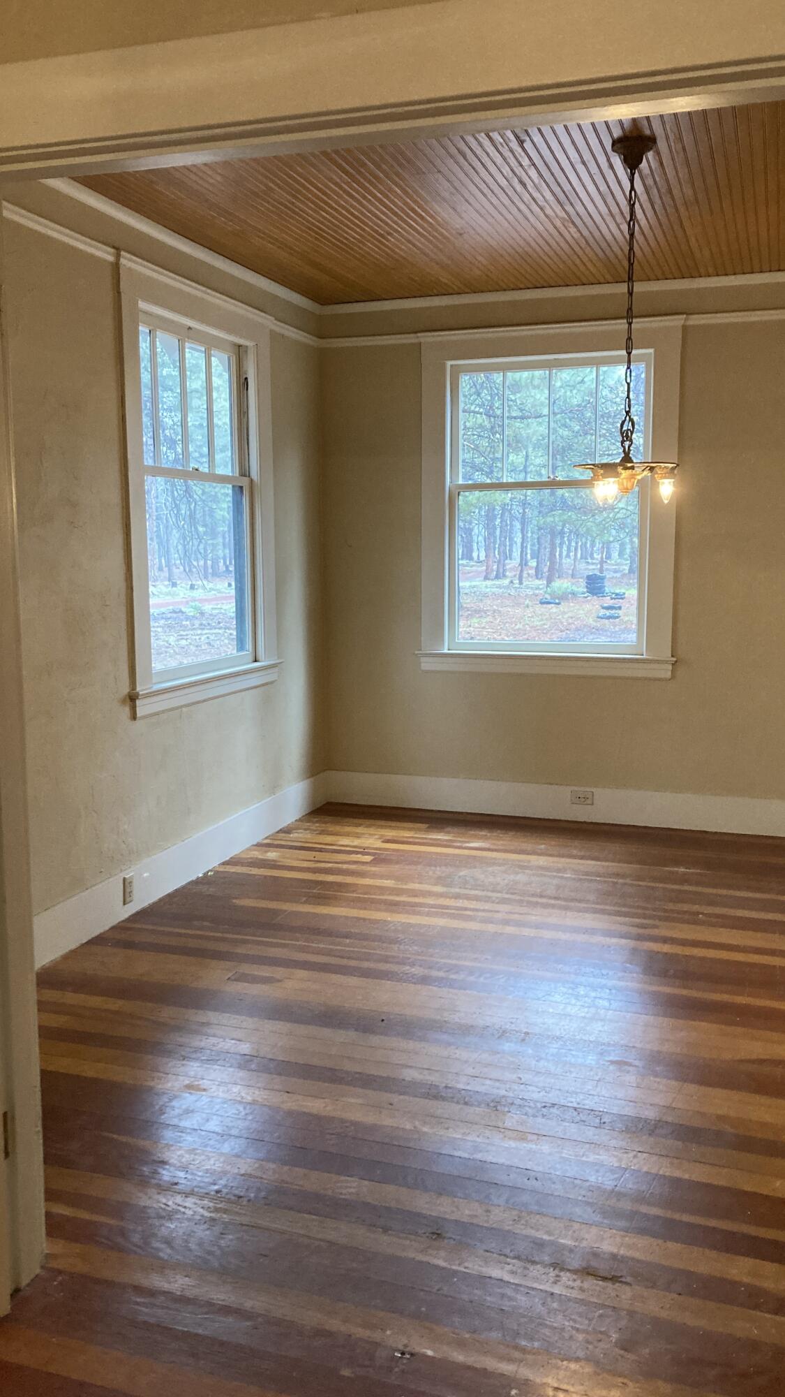 41008 Old School Road Fall River Mills, CA 96028 - Photo 15 of 53 a view of an empty room with wooden floor and a window