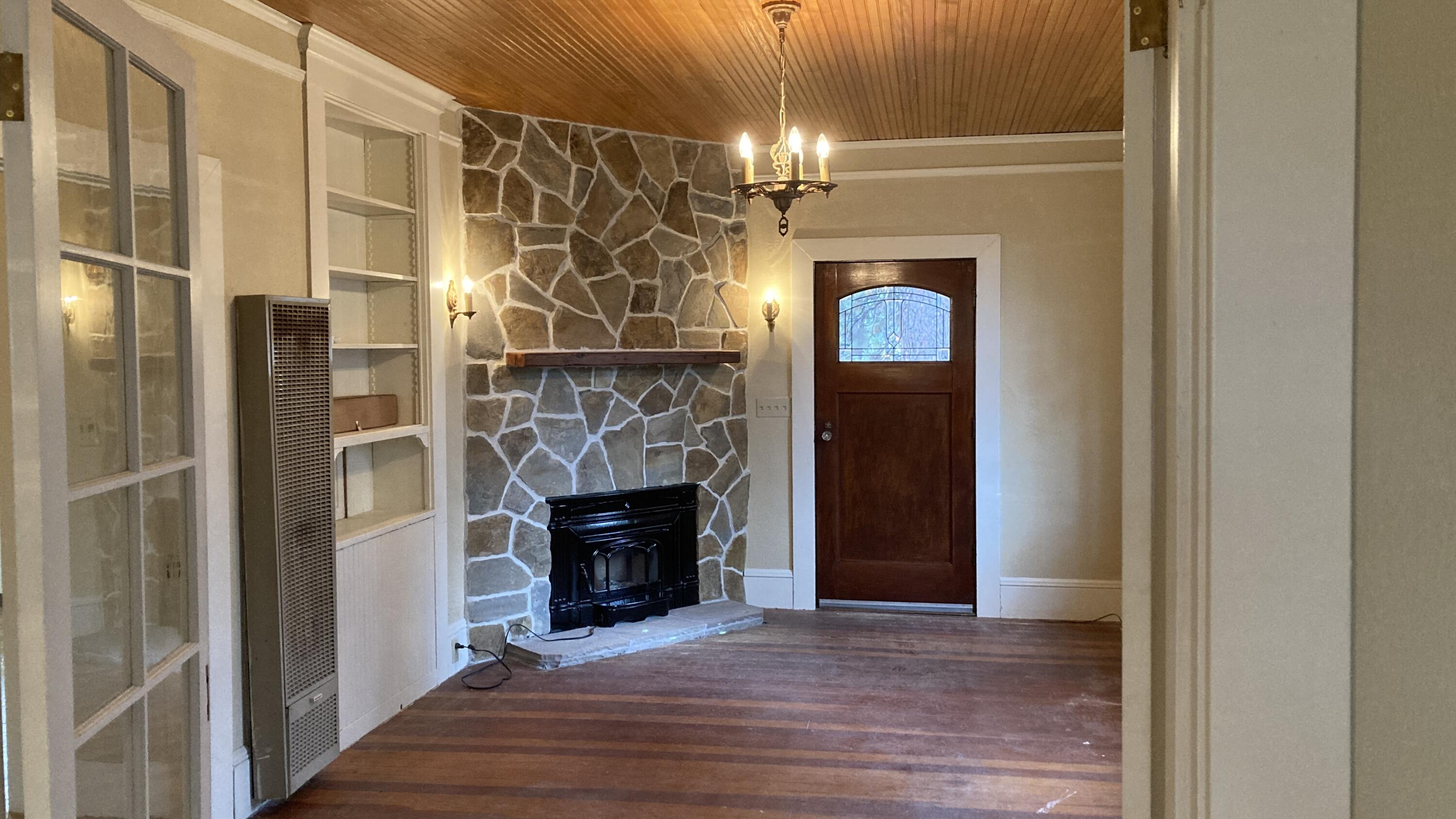 41008 Old School Road Fall River Mills, CA 96028 - Photo 8 of 53 a view of a livingroom with a fireplace and a chandelier