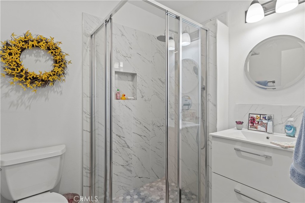 4214 Tosca Road Woodland Hills, CA 91364 - Photo 17 of 24 a bathroom with a toilet sink vanity and mirror