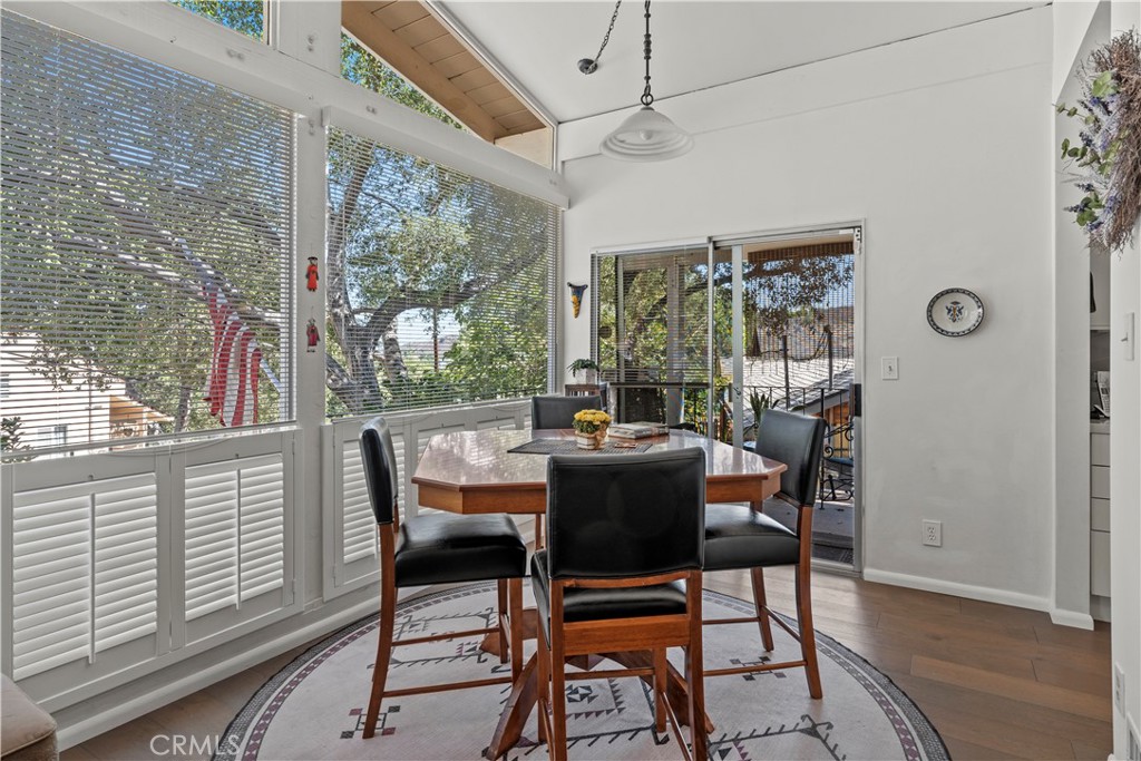 4214 Tosca Road Woodland Hills, CA 91364 - Photo 3 of 24 a dining room with furniture a chandelier and wooden floor