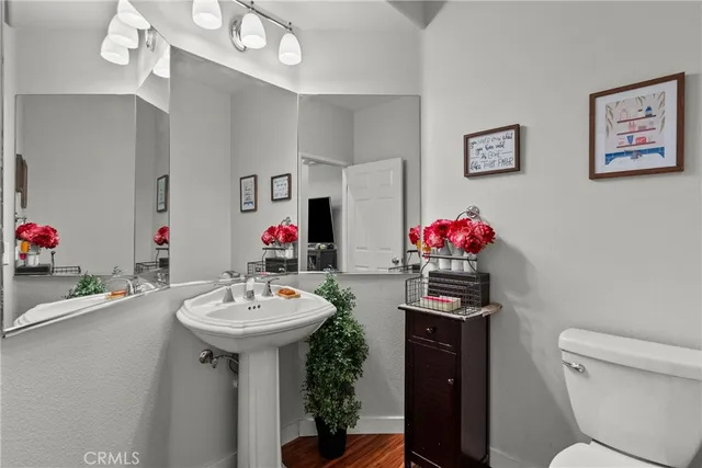a bathroom with a sink vanity mirror and toilet