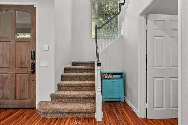 a view of entryway and hall with wooden floor
