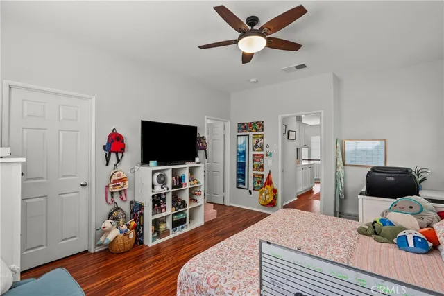 a bedroom with furniture and a flat screen tv