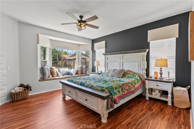 a bed sitting in a bedroom next to a window