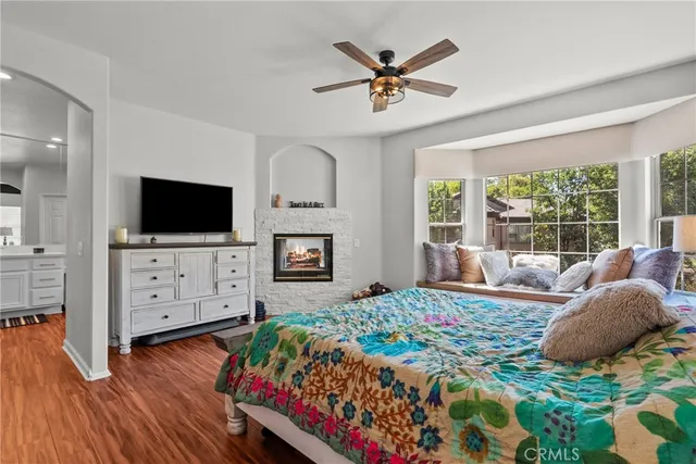 a bedroom with a bed and a flat screen tv on dresser