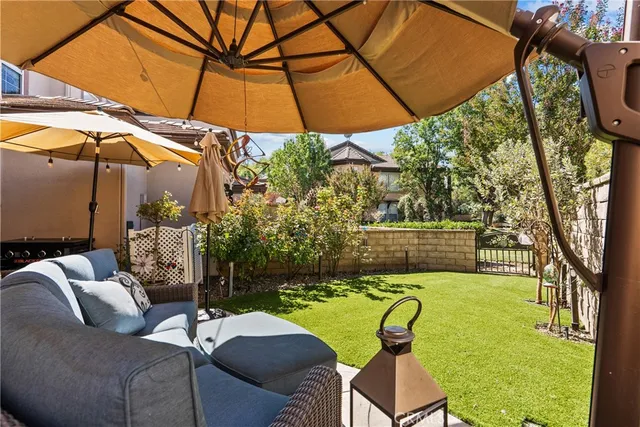 a view of backyard with seating space and trees