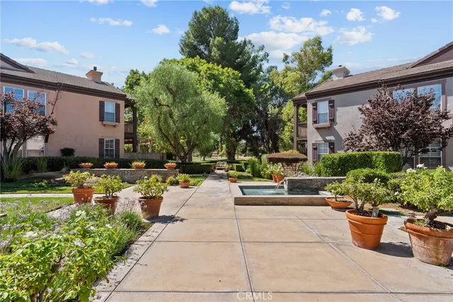 a view of a house with backyard sitting area and garden