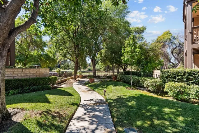 a view of yard with swimming pool and green space
