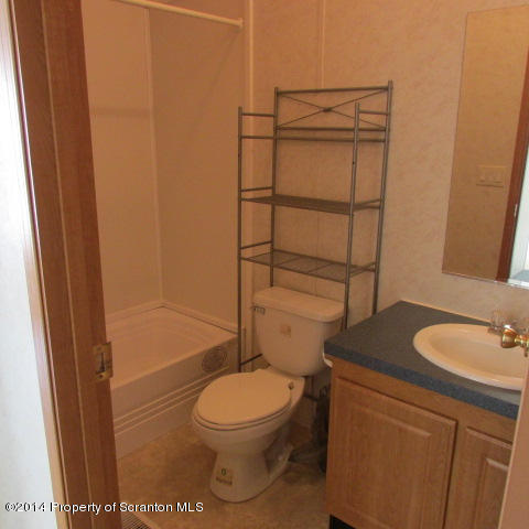 2000 Booth Road Hallstead, PA 18822 - Photo 11 of 15 a bathroom with a granite countertop toilet sink and shower